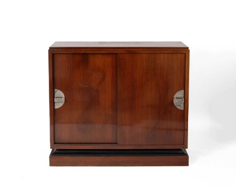 An Art Deco style mahogany cabinet with a pair of sliding doors each with white metal handle on a plinth base,124cm wide, 40c