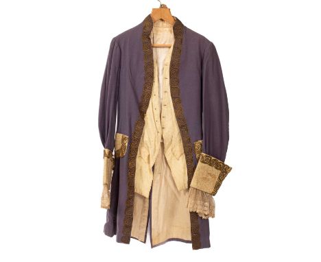 A Gentleman's frock coat, early 20th Century, blue with cream and lace cuffs, cream pockets and wirework embroidery, silk lin