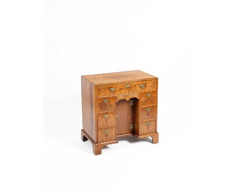 A George II walnut kneehole desk the chevron inlaid and crossbanded caddy moulded top above one from frieze drawer and three 