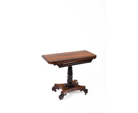 An early Victorian rosewood card table, the fold over top enclosing a green baize playing surface on reeded and carved column
