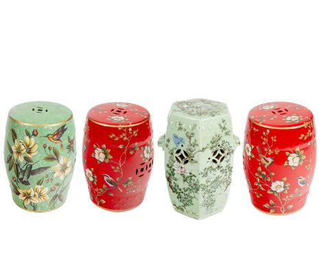 A pair of Chinese barrel shaped red ceramic garden seats with floral decoration, another similar seat in green with floral de