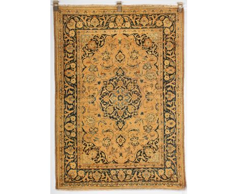 A Tabriz rug, North West Persia, the pale pink field centred by an indigo pendant medallion and framed by an indigo scrolling