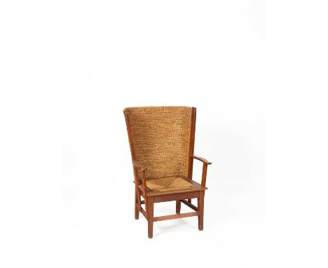 An Orkney Highland oak and woven rush back arm chair with square loose trap seat and square tapering legs united by square st