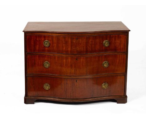 A 19th Century mahogany serpentine chest the moulded edge top above three drawers with brass handles, on bracket feet, the lo