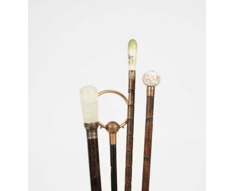 Four early 20th Century walking canes, including two with ceramic handles and a quartz handled walking caneProvenance:- Dunki