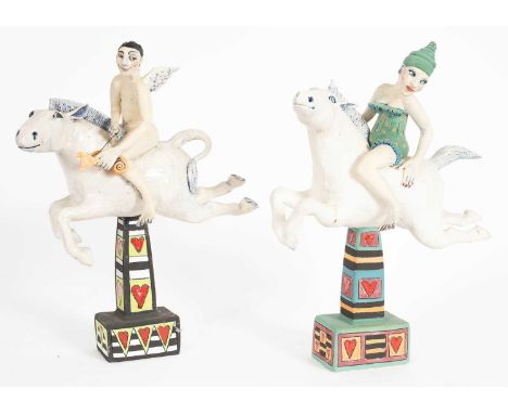 ARR A pair of Marie Prett ceramic sculptures of boy and girl acrobats riding on white horses, 45cm highProvenance: Dunkirk Ma