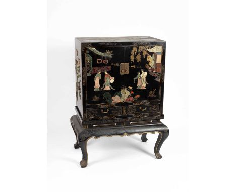 A 20th Century black lacquer and jadeite applied cabinet on stand the cabinet with Chinese figures in landscapes, the figures