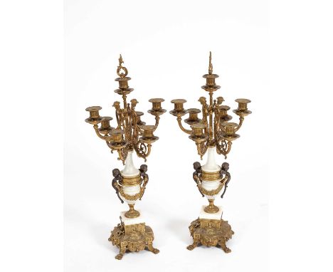 A pair of Italian Brevettato candelabra, six branch, severn light, of vase shape with gilt metal mounts and each mounted with