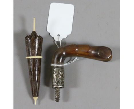 A silver mounted walking stick handle assayed London along with a bone and hardwood needel case formed as an umbrella.