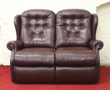 An oxblood leather two seater sofa.
