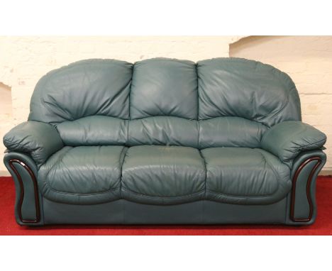A good quality green leather three seat sofa and matching two seat sofa with boxed leather care system.