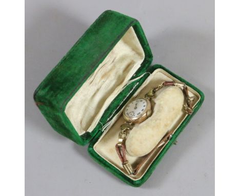 A ladies 9ct gold cased wristwatch with enamel face and subsidiary dial.