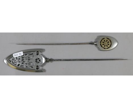 Two white metal eastern arrow heads.