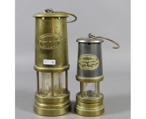 An Ashington Colliery brass cased miners lamp along with a smaller brass and chrome Ferndale miners lamp.