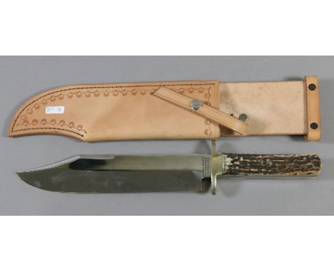 A tan leather sheathed bone handled bowie knife by Reg Copper of Sheffield England.