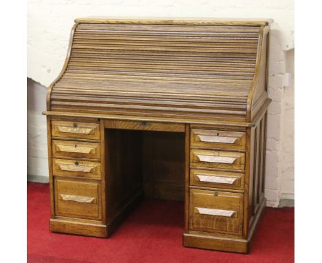 A large twin pedestal roll top desk with fitted interior.