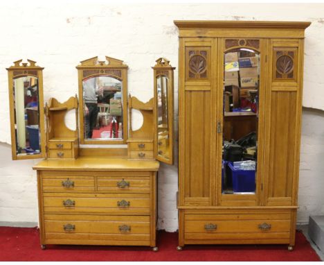 A Victorian light oak two part bedroom suite, comprising of a mirror fronted wardrobe and triple mirror dressing table both w