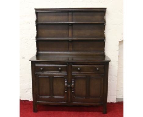 An Ercol dark oak kitchen dresser.