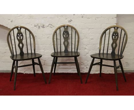 A set of three mid 20th century Ercol dining chairs with Prince of Wales motif backs.