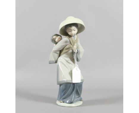 A large Lladro figure formed as an oriental woman with child on her back.