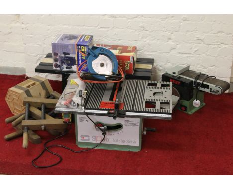 A collection of assorted wood working tools including a 10" table saw, router table with three routers, sanding machine, circ