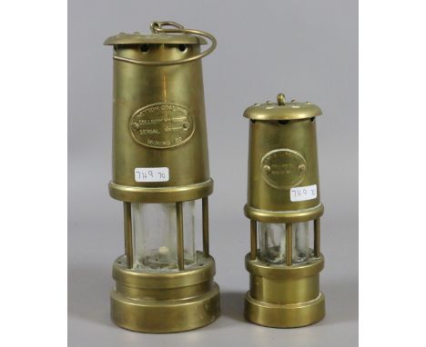 A Hetton Coal and Mining Company brass cased miners lamp along with a smaller brass miners lamp.