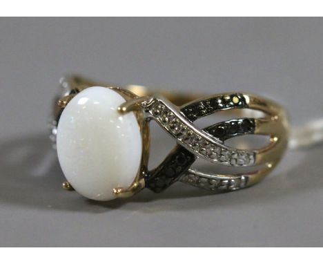 A ladies 9 carat gold opal ring with black and white diamond set shoulders, 2.92 grams, UK size P.5.