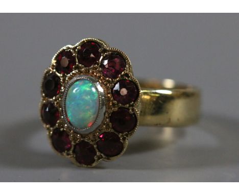 A ladies 9 carat gold old cut ruby and opal cluster ring, 5.02 grams, UK size O.