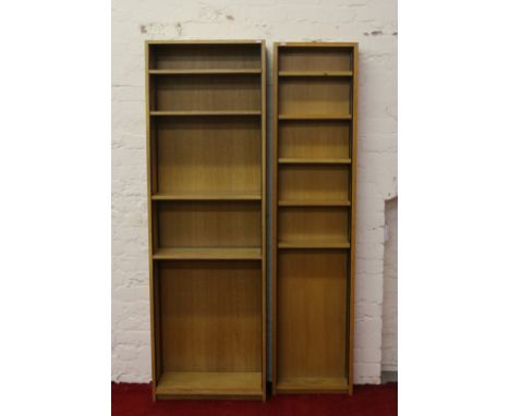 Two light oak bookcases with adjustable shelves.