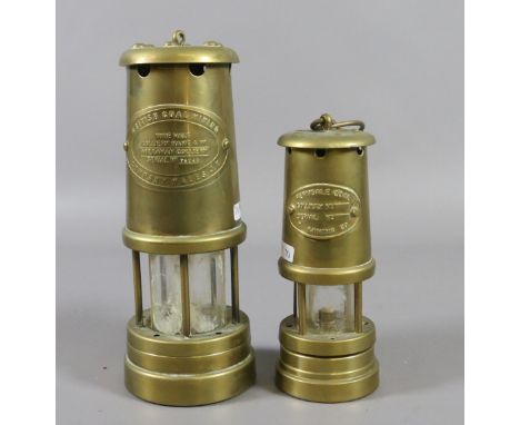 A brass cased Welsh miners safety lamp along with a smaller brass miners lamp.
