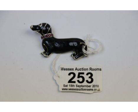 Silver brooch in the form of a dachshund with enamel decoration set with ruby eye and collar