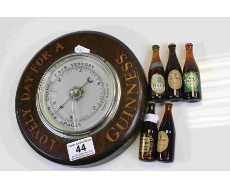 Wooden cased circular wall Barometer marked "Lovely Day for a Guinness" with five miniature bottles of beer to include Guinne