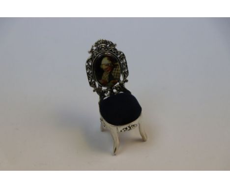 Miniature silver chair pin cushion with enamel picture of an elderly lady sewing