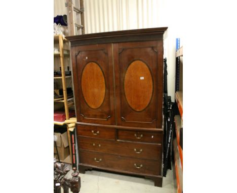 19th century Mahogany Linen Press, the two doors with central oval inlaid panels opening to reveal Three Linen Slides above a
