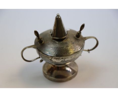 George V silver table lighter of circular pedestal form with twin handles, engine turned decoration to lid, incised bands to 