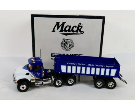 First Gear - Granite - A die-cast Mack Granite tractor with dump trailer in 1:34 scale - The model in blue livery is presente