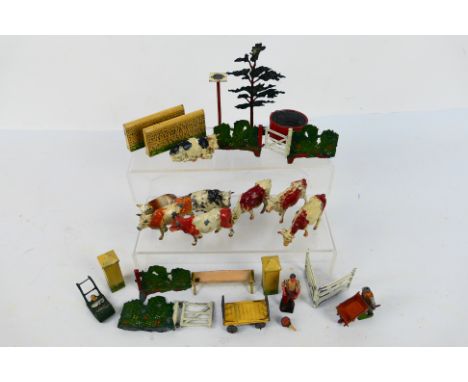 Britains - A collection of Britains Farm items including 8 x cows, 2 x figures, a tree, 2 x gateways, a feed trough and other