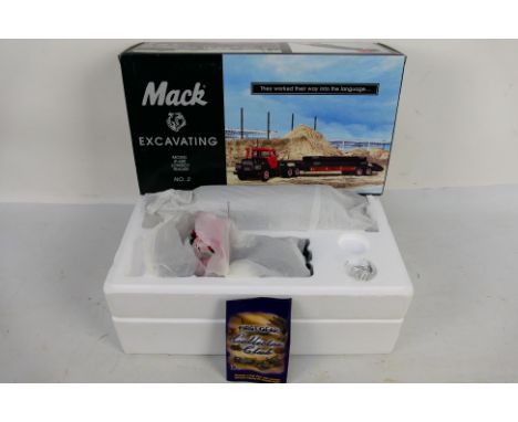 First Gear - A die-cast Mack Excavating Model R-600 Lowboy Trailer - The model is presented within polystyrene packaging whic