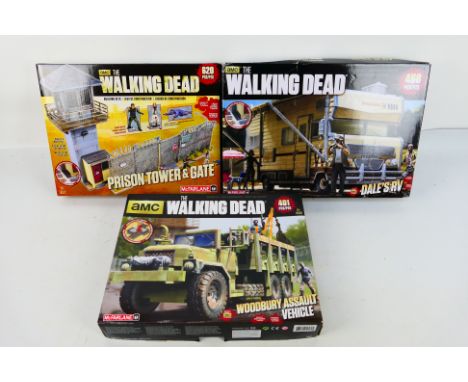 McFarlane - Three boxed McFarlane 'The Walking Dead' building sets. Lot consists of #14528 Dale's RV; #14527 Prison Tower & G