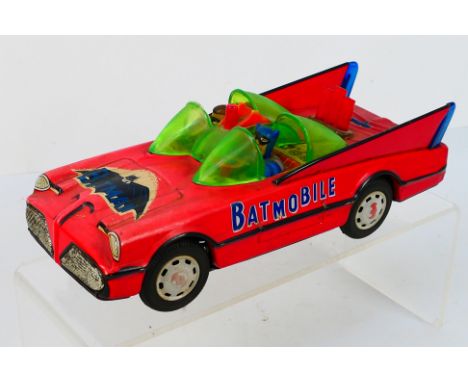 Cien Ge Toys - An unboxed battery operated tinplate 'Batmobile', CG-1228. The model in red with lime green windscreen looks t