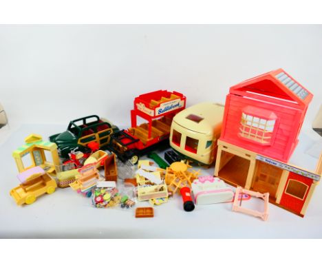 Sylvanian Families - A collection of unboxed Sylvanian Families toys. Lot consists of a vintage style London Bus; caravan; mo