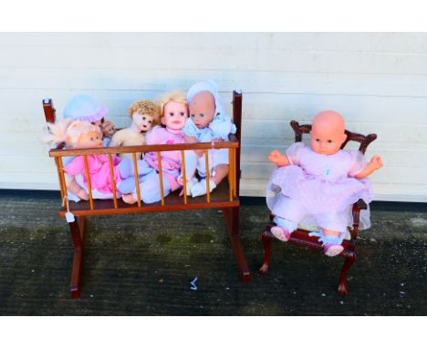 Doll chair, swinging cot crib and dolls - A swinging cot, chair and 7 dolls. Cot is approx 65 cm (l), 68 cm (h), 47 cm (w). c