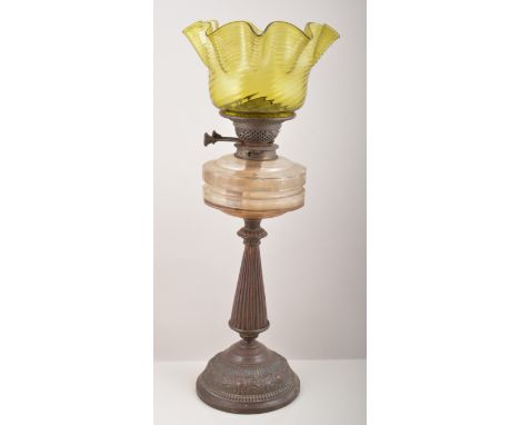 Victorian bronzed oil lamp, fluted and tapering column, clear glass reservoir with an olive coloured moulded glass shade, 59c