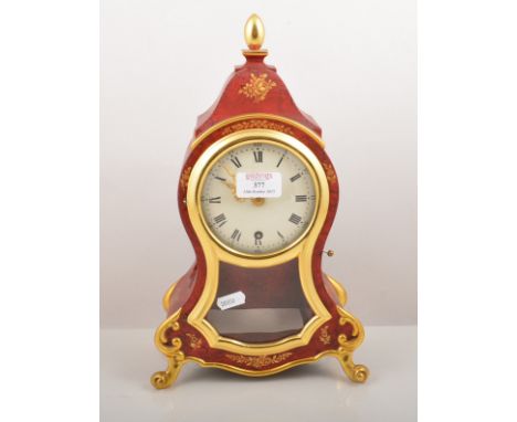 Reproduction red lacquer effect and parcel gilt balloon shape mantel clock, Zenith movement, 35cm with a wall bracket to matc
