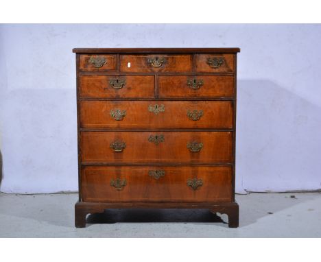 Walnut chest of drawers, in part 18th Century, the top with stringing and banding, fitted with three narrow drawers over two 