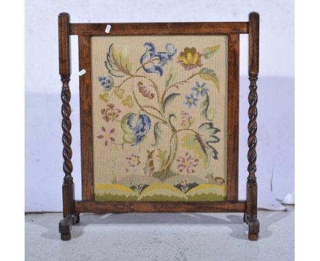 Edwardian brass framed fire screen, bevelled mirror panel, painted with roses, height 67cm and an oak framed fire screen with
