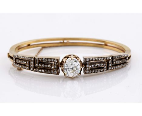 A rigid bracelet, neoclassical style, 750/1000 gold, pierced meander decoration, set with rose cut diamonds, and antique bril