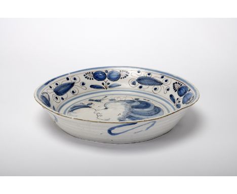 A basin, faience, blue and vinous "Spiders" decoration "Female bust in profile with headdress, flanked by a bird and flower",