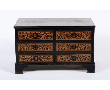 A large chest with drawers and simulated drawers, light exotic wood and teack, partial ebony and sissoo covering, ebony and i