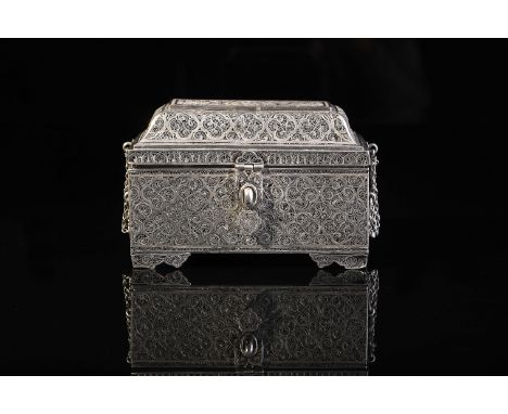 A casket with pyramidal cover, silver filigree, scalloped keyhole escutcheon, hinges and feet, interior with grille for six v